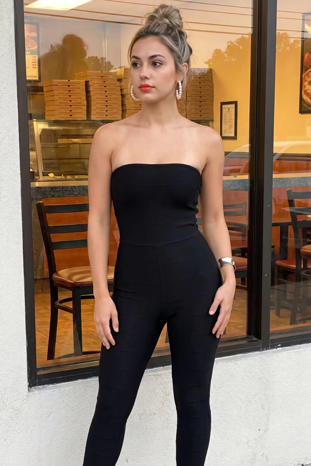 Woman in black strapless bandeau jumpsuit