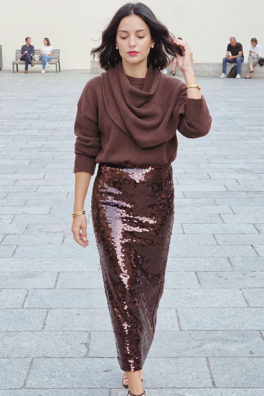Woman in chocolate brown cowl neck oversized knit sweater and brown sequin pencil maxi skirt