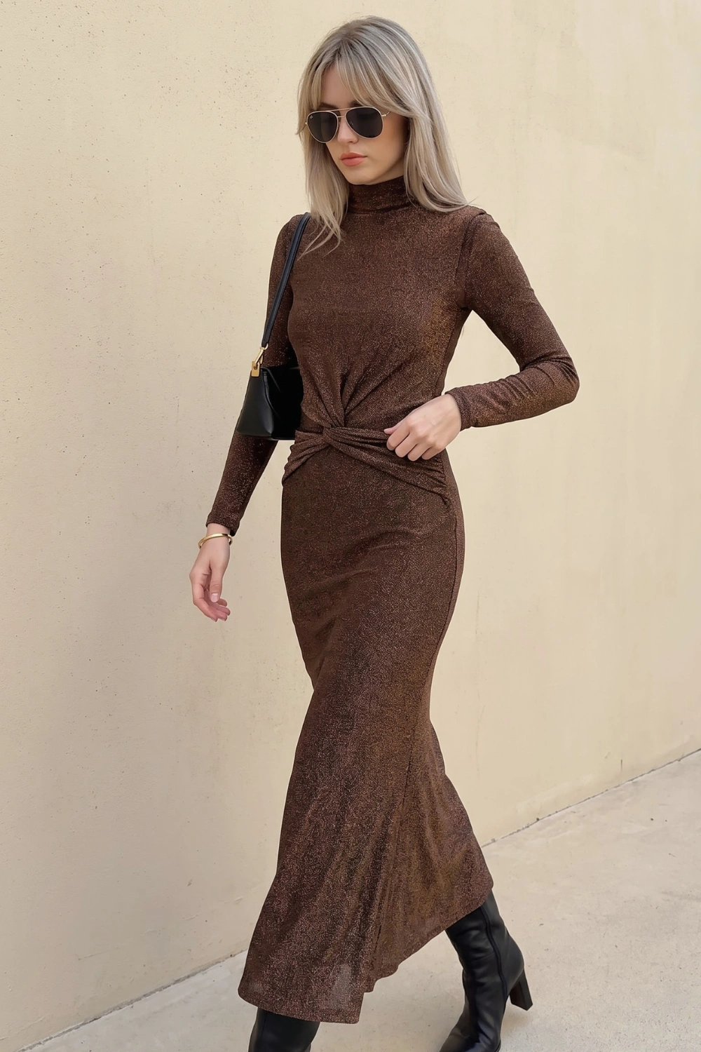 Woman in chocolate brown metallic shimmer turtleneck twist knot long sleeve maxi dress