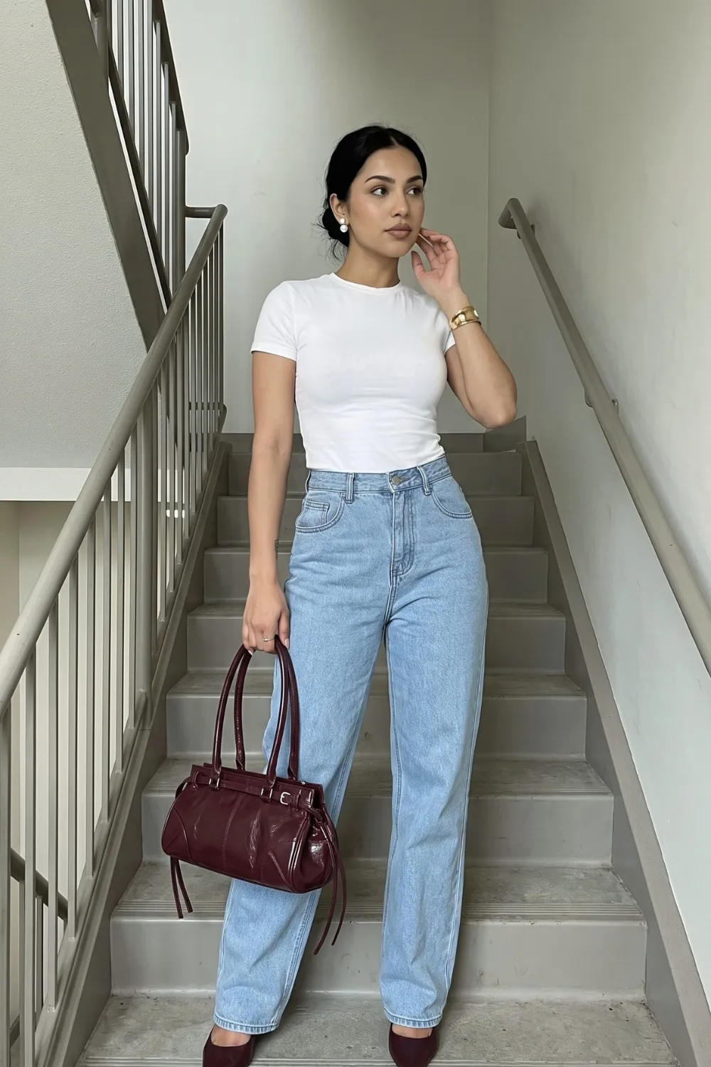 Woman in white fitted crew neck t-shirt with light blue high waist wide leg jeans